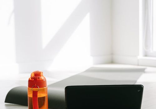 A clean, open space with a yoga mat, suitable for home workouts.