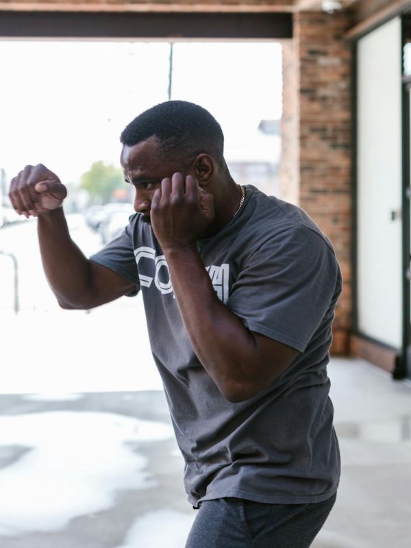 Man in a focused stance, preparing for a bodyweight exercise.
